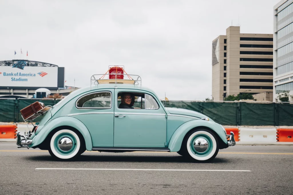 Volkswagen Beetle, a classic German car, on a trip, symbolizing the import of German cars and their popularity in international markets